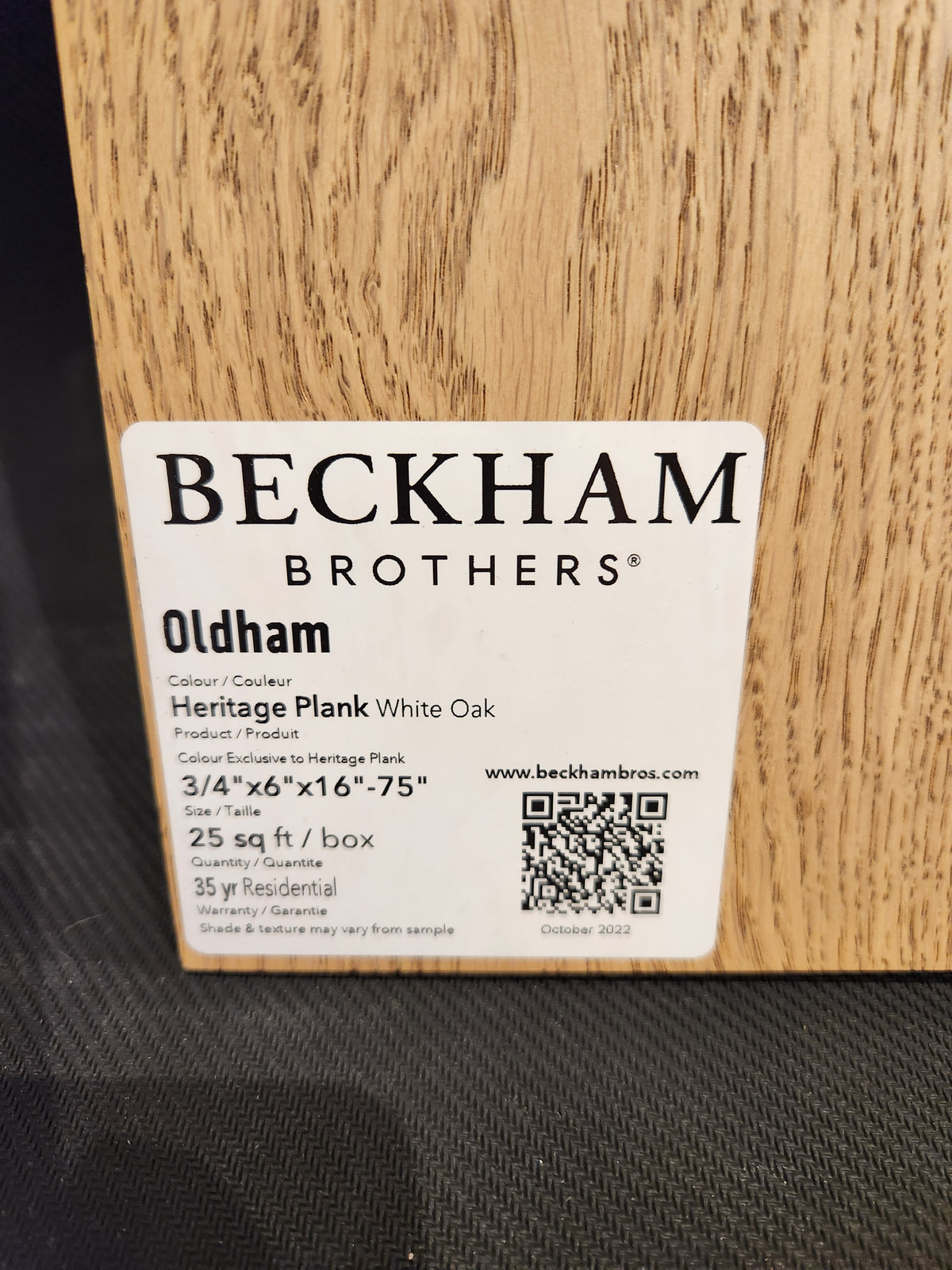 Label on wood sample: "Beckham Brothers Heritage Plank White Oak" premium hardwood flooring with QR code.