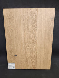 Heritage Plank White Oak flooring sample by Beckham Brothers shown on black background. Premium hardwood option.