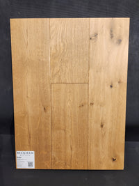 Heritage Plank White Oak by Beckham Brothers, durable flooring with grain and knots shown vertically on a dark background.