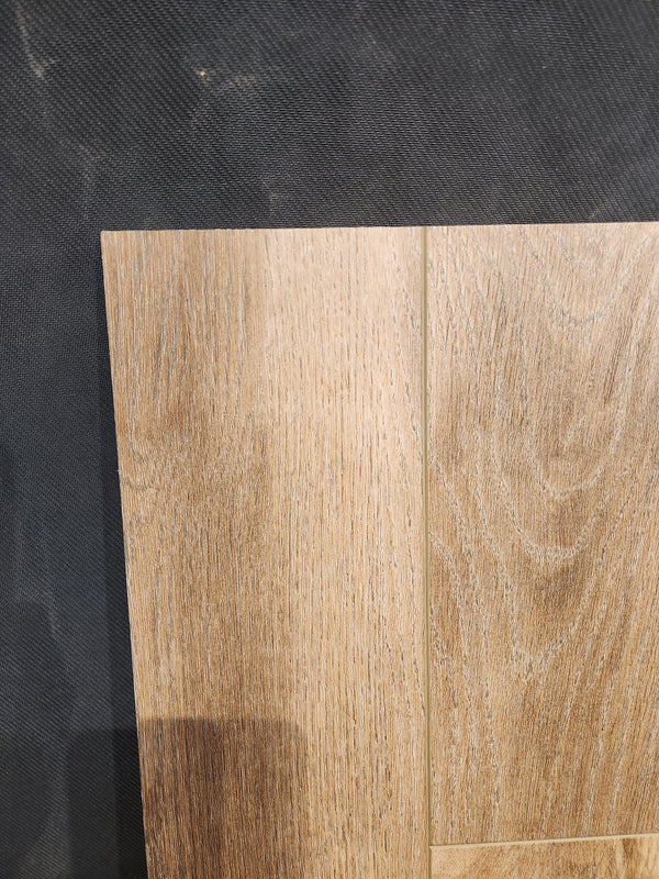 Hang Loose Luxury Vinyl (Glue-Down Plank) by Beckham Brothers shown on a dark surface, highlighting its grain and seams.