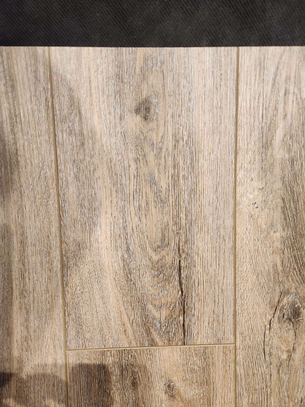 Close-up of Beckham Brothers Hang Loose Luxury Vinyl (Glue-Down Plank) featuring wood grain and a scratch-resistant finish.
