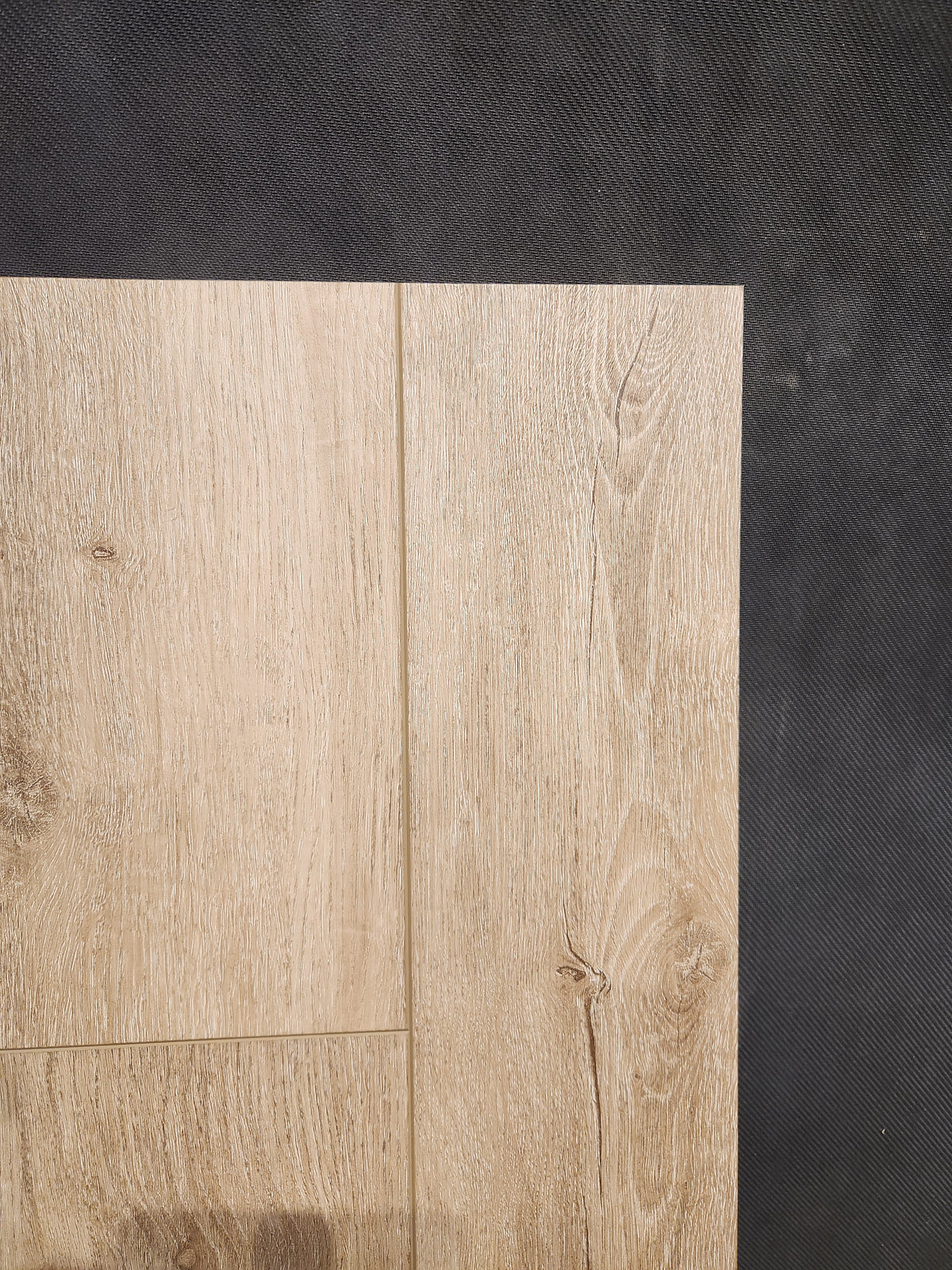 Hang Loose Luxury Vinyl (Glue-Down Plank) by Beckham Brothers is shown on a dark textured background.