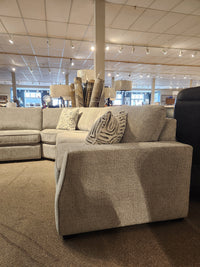 Decor-rest 2456 3-Piece Sectional in light gray with patterned pillows, displayed in a carpeted showroom.