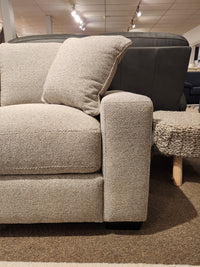 Donald Choi Laguna Sofa features high-density foam seat, beige upholstery, and pillow, shown on a brown carpet.