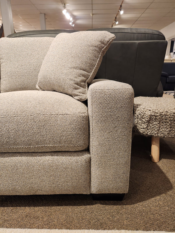 Donald Choi Laguna Sofa features high-density foam seat, beige upholstery, and pillow, shown on a brown carpet.