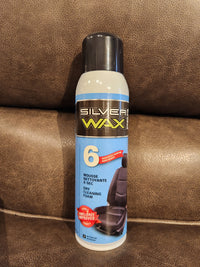 A can of Eric Cox Spray Carpet Cleaner sits on a brown leather surface.