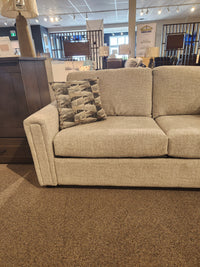 Simmons Upholstery 9350 Queen Sofa Bed with track arms and patterned cushion on display in a showroom.