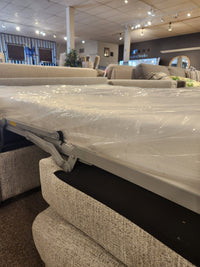 Unfolded Simmons Upholstery 9350 Queen Sofa Bed with track arms and a plastic-wrapped mattress in a showroom.
