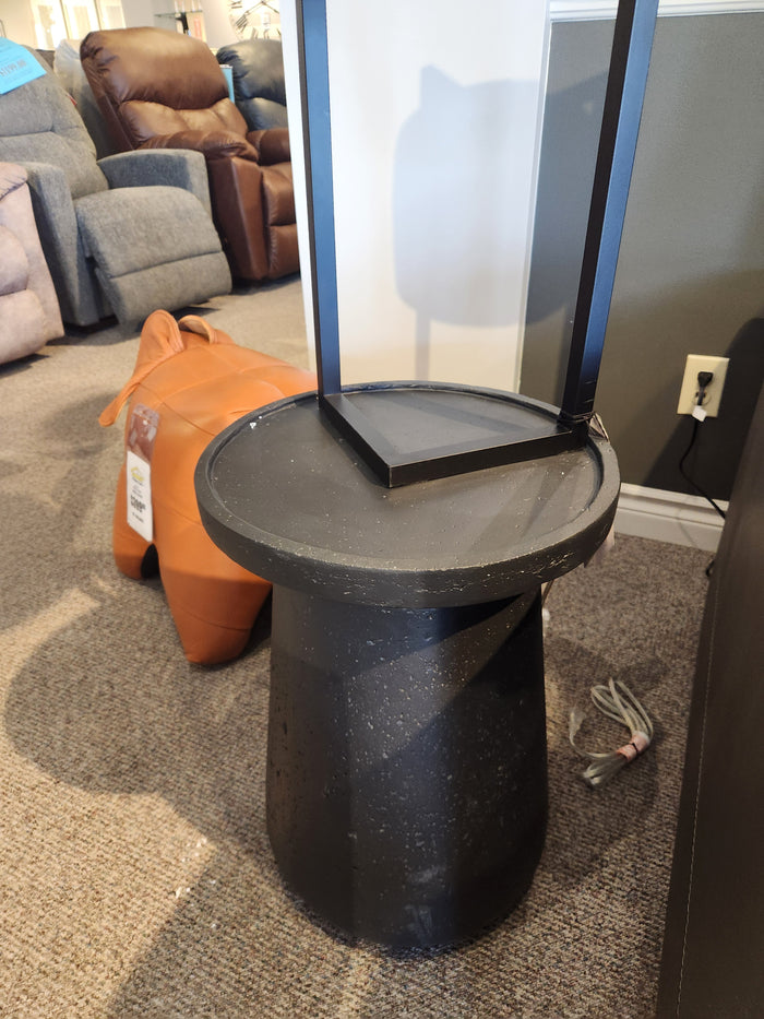 The Maru 15" Accent Table by Donald Choi stands beside a brown animal-shaped object on a carpeted floor.