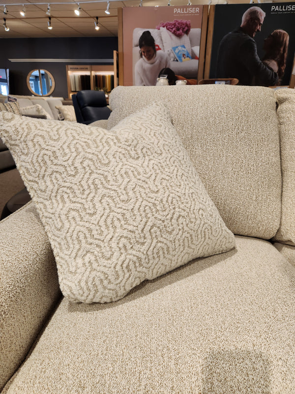 A beige textured throw pillow accents the Decor-rest 2981 Loveseat with box seat cushions in a showroom.