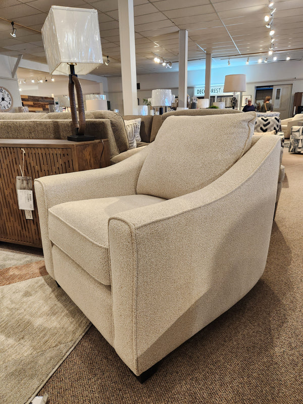 Decor-rest 2981 Chair features box seat cushions and a square back, displayed in a showroom under bright lighting.