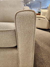 Close-up of the armrest and box seat cushions of the Decor-rest 2981 Chair in light beige with sinuous springs.