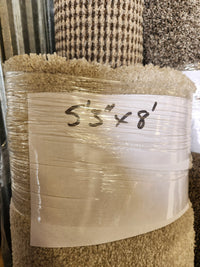 Flooring CLEARANCE Carpet Remnant 5'3" x 8', beige, medium pile, wrapped in plastic with white label.