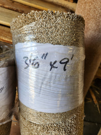A Flooring CLEARANCE Carpet Remnant 3'6" X 9', medium pile Tan, rolled and wrapped in plastic with a sign.