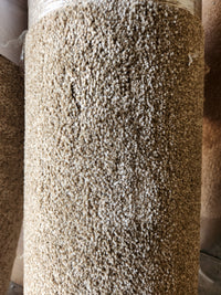 Close-up of a rolled Carpet Remnant 3'6" x 9' by Flooring CLEARANCE with a textured, medium pile looped surface.