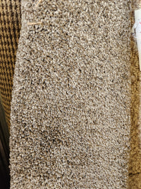 Close-up of Flooring CLEARANCE Carpet Remnant 6' X 7', tan with woven pattern on the left side.