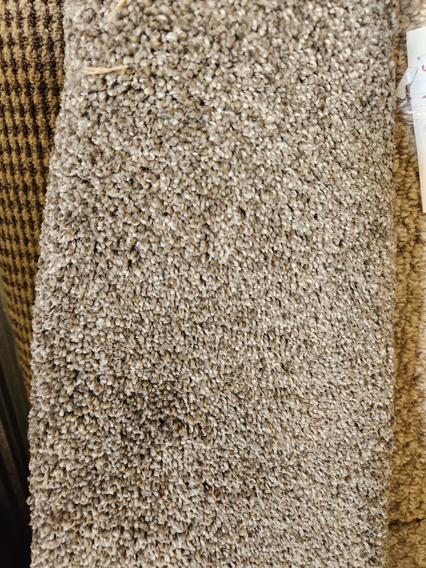 Close-up of Flooring CLEARANCE Carpet Remnant 6' X 7', tan with woven pattern on the left side.