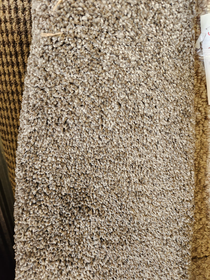 Close-up of Flooring CLEARANCE Carpet Remnant 6' X 7', tan with woven pattern on the left side.