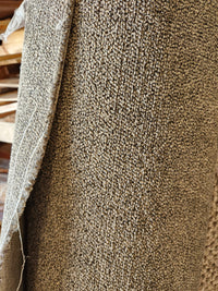 Close-up of Flooring CLEARANCE Carpet Remnant 3'4" x 21'6", beige low pile with frayed edge on left.