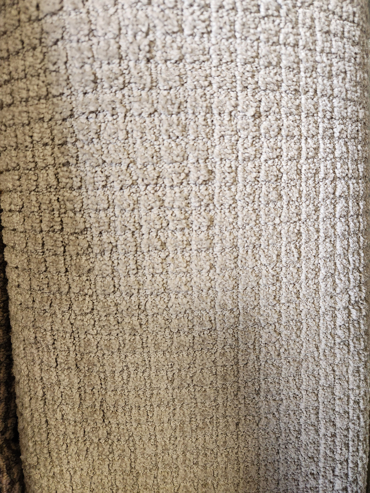 Close-up of Flooring CLEARANCE Carpet Remnant 12' X 6'4", showing textured beige grid pattern and visible fibers.