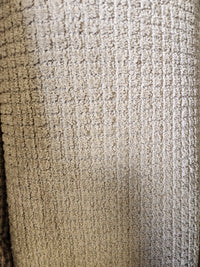 Close-up of Flooring CLEARANCE Carpet Remnant 12' X 6'4", showing textured beige grid pattern and visible fibers.