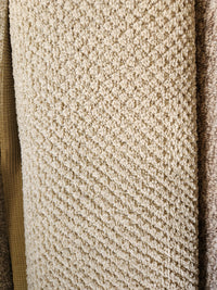 Close-up of Flooring CLEARANCE Carpet Remnant 6' X 8'7" in beige, low pile with a diamond pattern among samples.