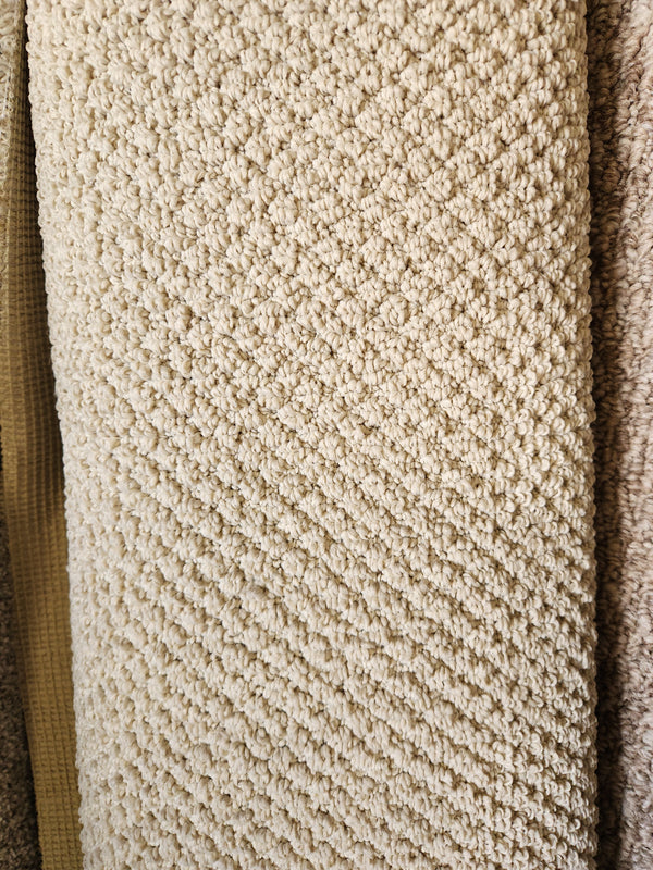 Close-up of Flooring CLEARANCE Carpet Remnant 6' X 8'7" in beige, low pile with a diamond pattern among samples.