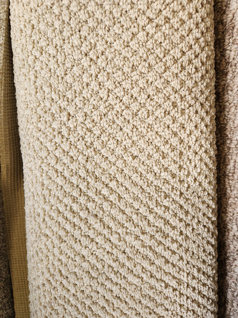 Close-up of Flooring CLEARANCE Carpet Remnant 6' X 8'7" in beige, low pile with a diamond pattern among samples.