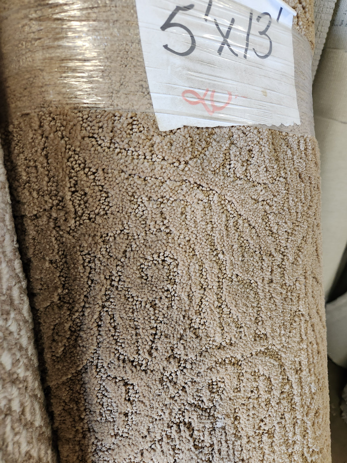 Close-up of Flooring CLEARANCE Carpet Remnant 5' X 13' with a "5 x 13" label on the packaging.