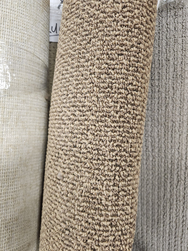 Close-up of Flooring CLEARANCE Carpet Remnant 6'2" X 4'2", low pile in beige/brown with mixed textures.