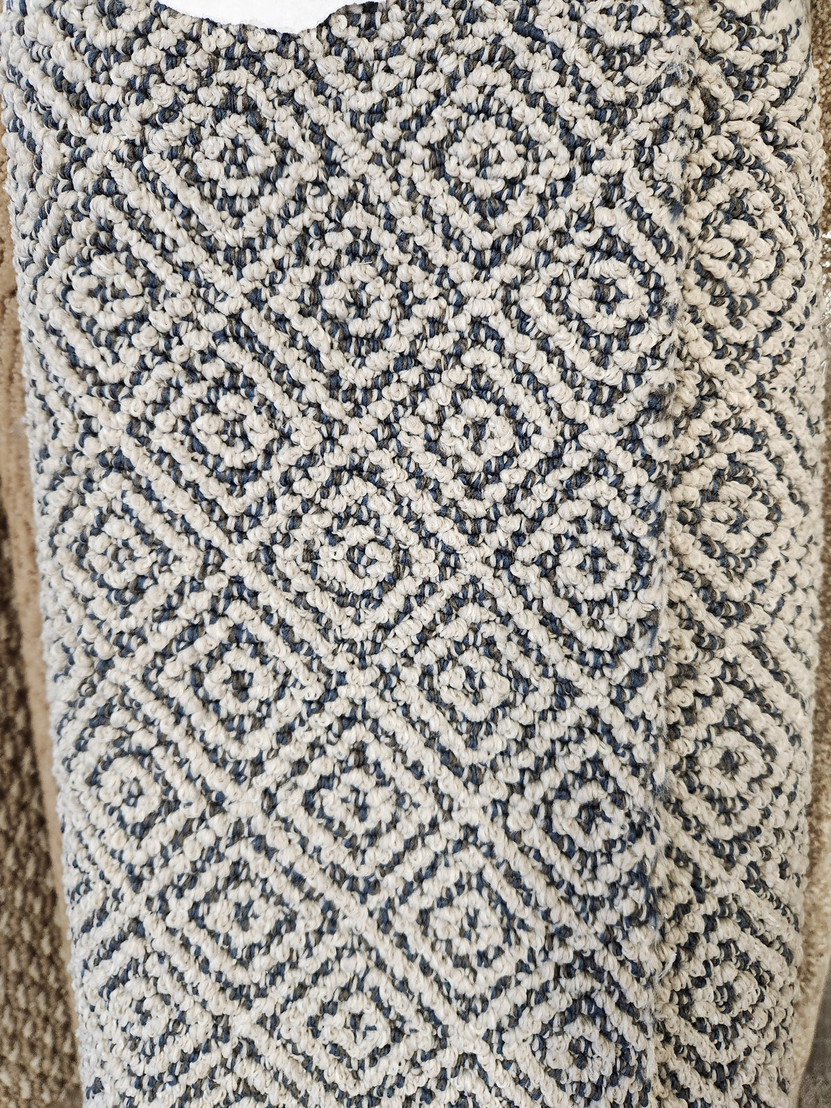 Close-up of Flooring CLEARANCE Carpet Remnant 3'6" X 8'6", a beige and dark gray geometric low pile textured rug.