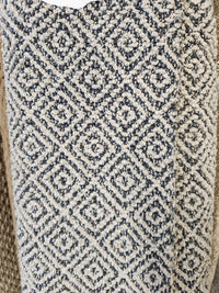 Close-up of Flooring CLEARANCE Carpet Remnant 3'6" X 8'6", a beige and dark gray geometric low pile textured rug.
