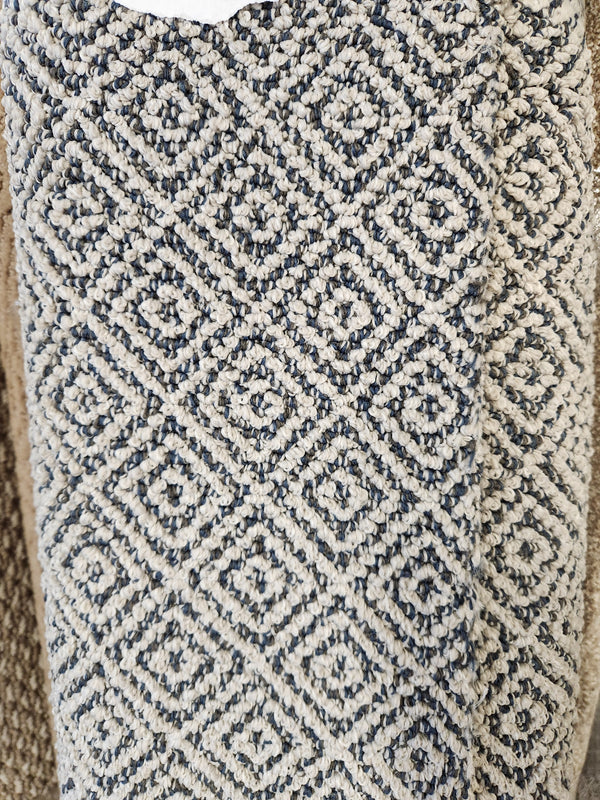 Close-up of Flooring CLEARANCE Carpet Remnant 3'6" X 8'6", a beige and dark gray geometric low pile textured rug.