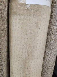 Flooring CLEARANCE Carpet Remnant 4' X 11', beige with tan dots, low pile, shown upright among other rolls.