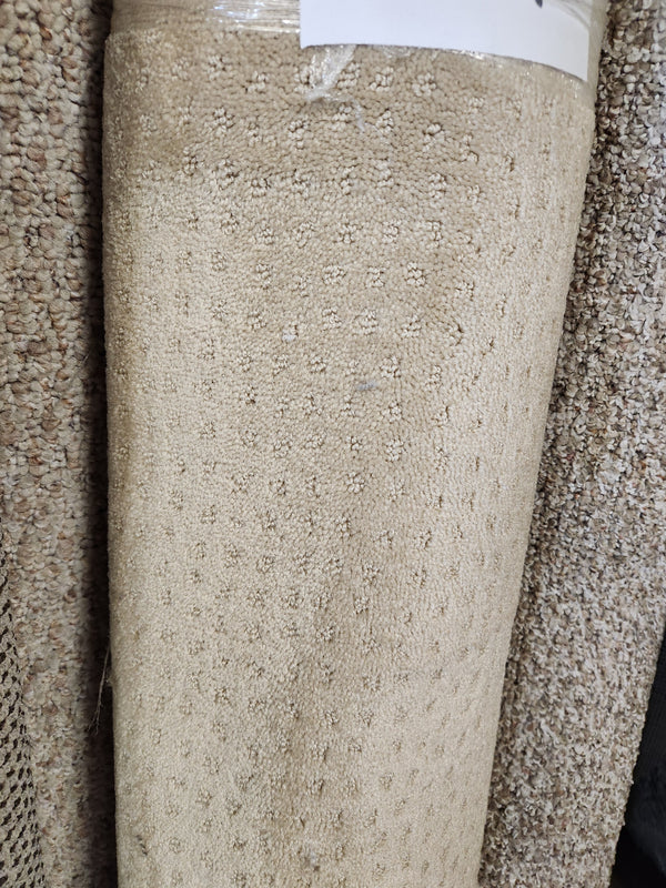 Flooring CLEARANCE Carpet Remnant 4' X 11', beige with tan dots, low pile, shown upright among other rolls.