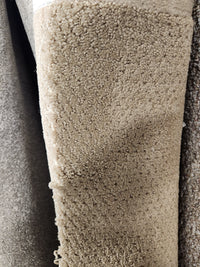 Close-up of Flooring CLEARANCE Carpet Remnant 5'9" X 4'8", tan, dotted texture, soft medium pile, subtle looped pattern.