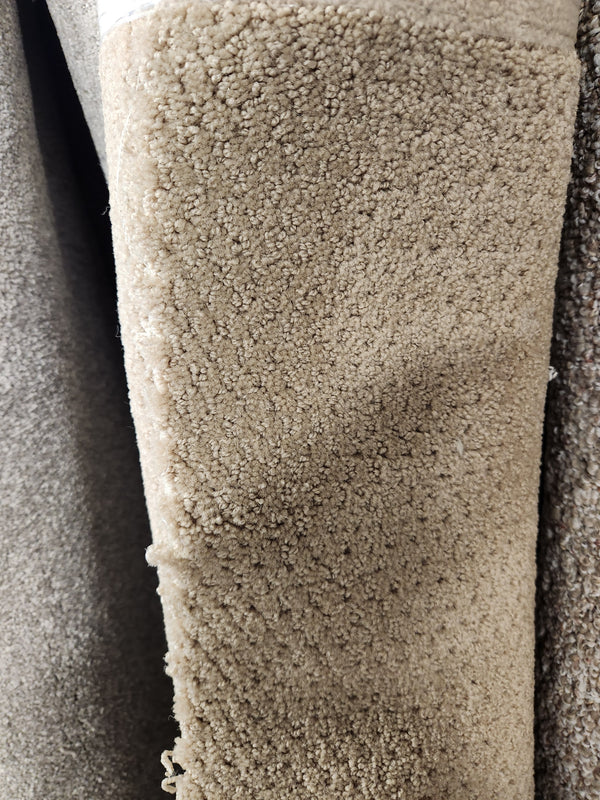 Close-up of Flooring CLEARANCE Carpet Remnant 5'9" X 4'8", tan, dotted texture, soft medium pile, subtle looped pattern.