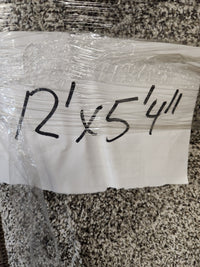 A handwritten sign on the Flooring CLEARANCE Carpet Remnant 12' X 5'4" dark grey rug notes its size in black marker.
