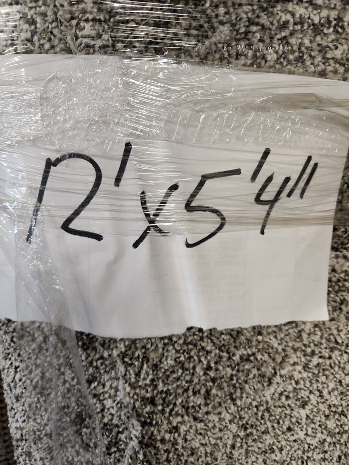 A handwritten sign on the Flooring CLEARANCE Carpet Remnant 12' X 5'4" dark grey rug notes its size in black marker.