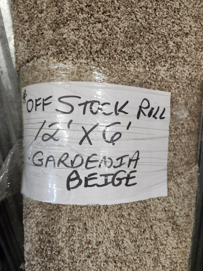 A Carpet Remnant 12' X 6' by Flooring CLEARANCE in beige with handwritten label, medium pile.