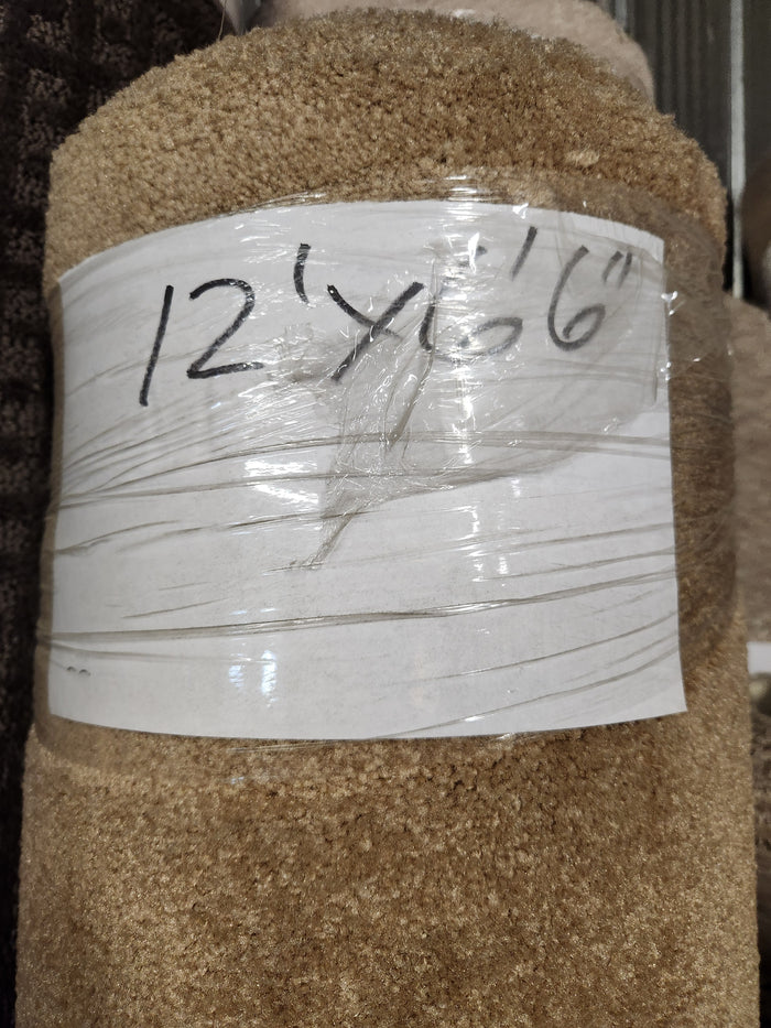A Flooring CLEARANCE Carpet Remnant 12' x 6'6" in beige, wrapped in plastic with handwritten label.