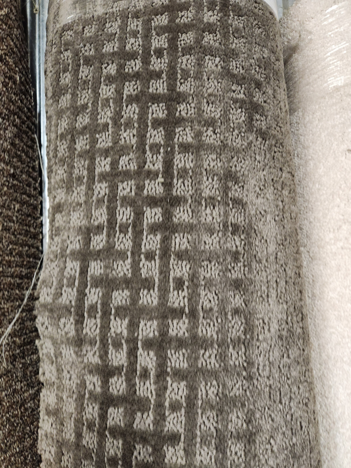 A close-up of Flooring CLEARANCE Carpet Remnant 11'6" x 7'6" with a geometric square pattern, in-store display.
