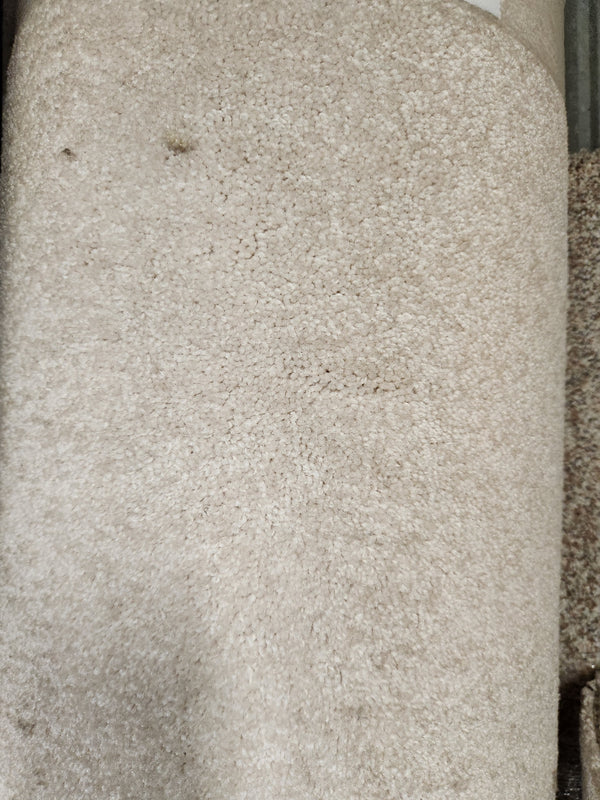 Close-up of Flooring CLEARANCE Carpet Remnant 7'5" x 14'11", beige, soft textured medium pile with subtle indent marks.