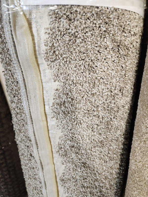 A close-up of the Flooring CLEARANCE Carpet Remnant 12' X 4'6" shows its medium pile and neatly stitched edge.