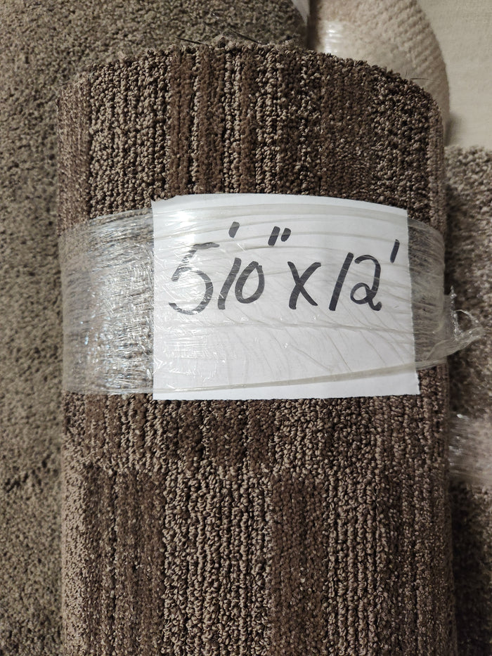 A low pile, dark brown Flooring CLEARANCE Carpet Remnant 5'10" x 12', rolled up in clear plastic.