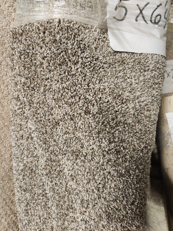 A close-up of a rolled-up Flooring CLEARANCE Carpet Remnant 5' X 6'4" with a handwritten dimension label.