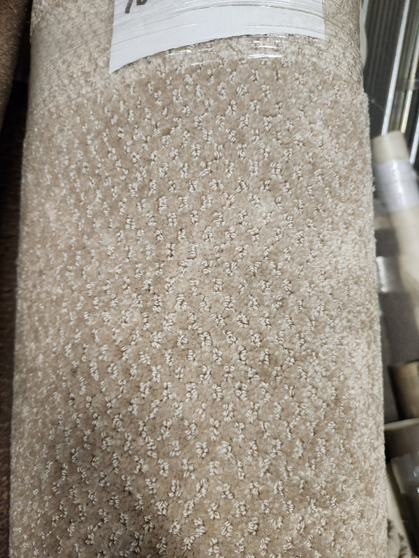 Close-up of Flooring CLEARANCE Carpet Remnant 12' X 6'10" in beige with a subtle dotted geometric pattern and price label.