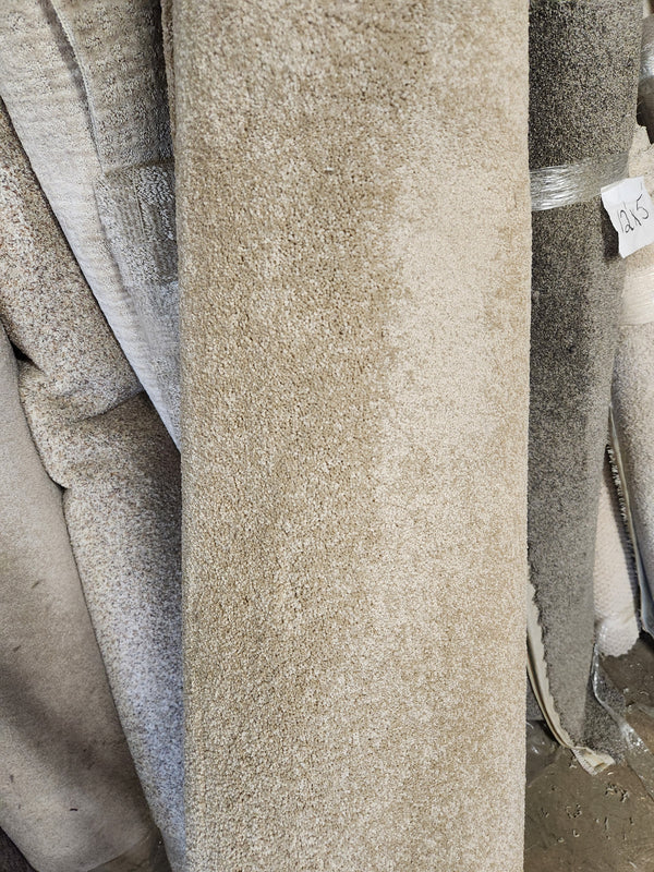 Several Flooring CLEARANCE Carpet Remnant 8'6" X 9' rolls in beige and grey are stacked vertically with a price tag.