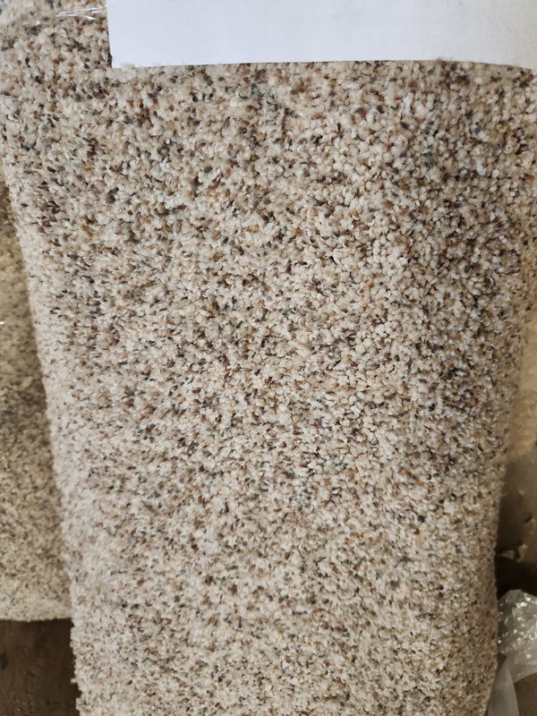 Close-up of Flooring CLEARANCE Carpet Remnant 12' X 2'9" roll in beige and brown with a textured high pile surface.