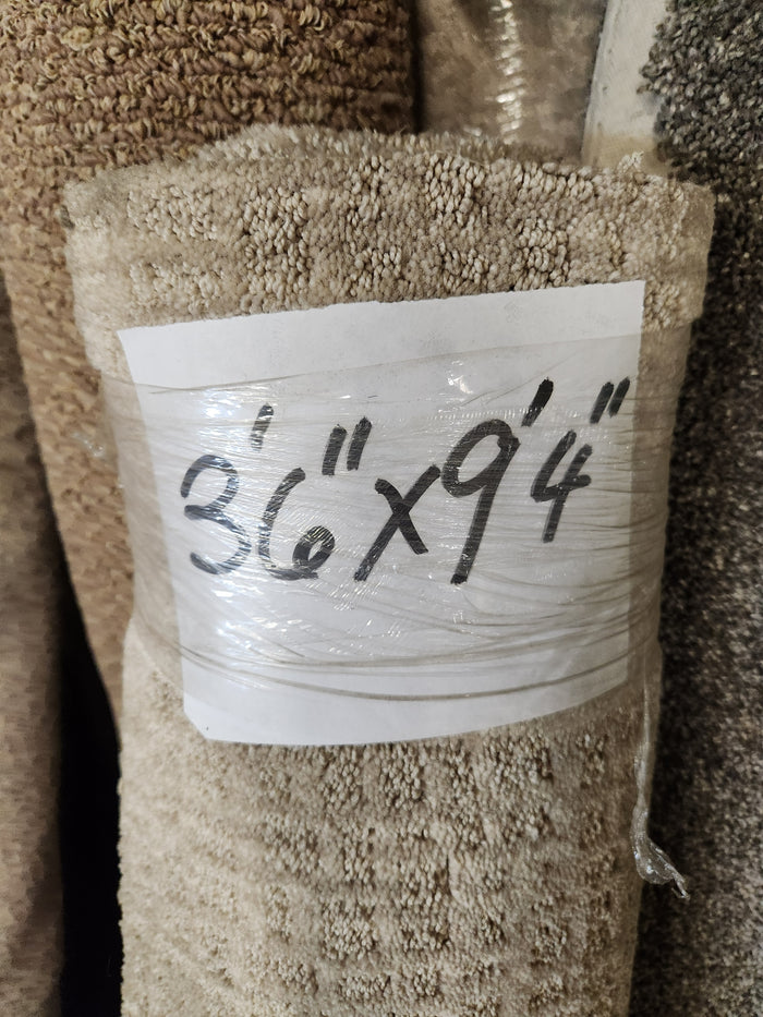 Flooring CLEARANCE Carpet Remnant 8'6" x 9'4", tan pattern beige, low pile, wrapped in plastic.